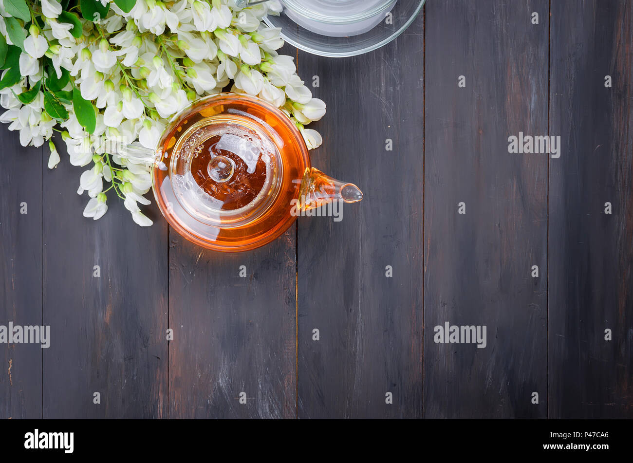 Healing herbal tea with honey from acacia flowers brewed in a tea pot