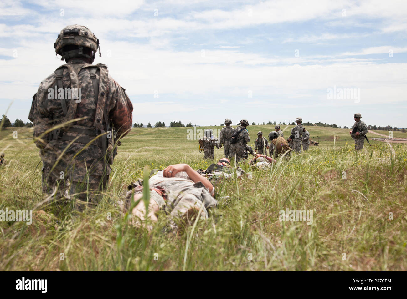 U.S. Army Soldiers of the 396th Medical Company (Ground Ambulance) extract wounded soldiers to a landing zone during a mass casualty training lane for the Golden Coyote exercise, in Camp Guernsey, Wyo., June 18, 2016.  The Golden Coyote exercise is a three-phase, scenario-driven exercise conducted in the Black Hills of South Dakota and Wyoming, which enables commanders to focus on mission essential task requirements, warrior tasks and battle drills. (U.S. Army photo by Spc. Chenyang Liu/Not Released) Stock Photo