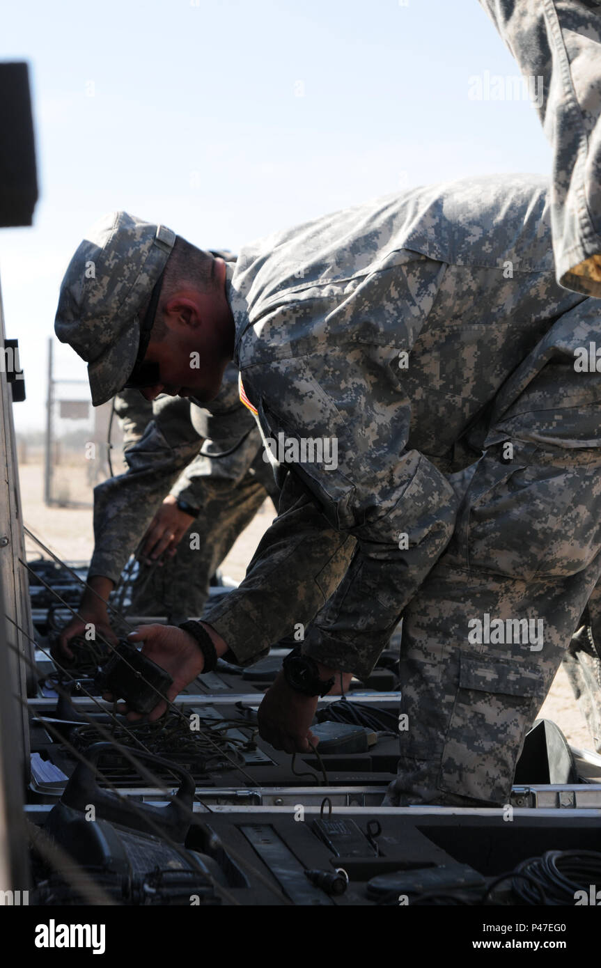 A North Carolina Army National Guard soldier assigned to the 630th Combat Sustainment Support Battalion inspects a Multiple Integrated Laser Engagement System (MILES) for defaults during the Reception Staging Onward Movement phase of the 16-07 National Training Center Rotation in Fort Irwin, California, June 6, 2016. The NTC is a training facility designed to simulate real-life combat scenarios testing warriors’ readiness utilizing their military occupational specialty in a high-up-tempo environment.  (U.S. Army National Guard photo by Sgt. Leticia Samuels, 382nd Public Affairs Detachment/Rele Stock Photo