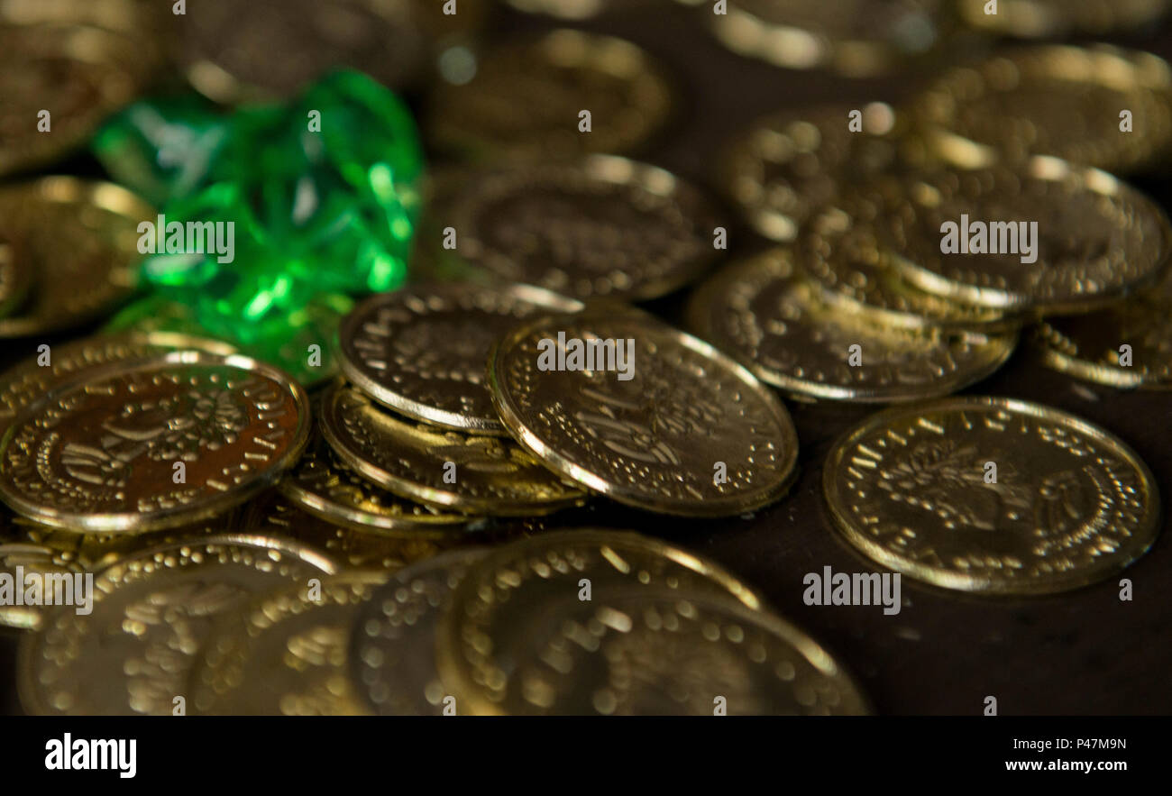 Fake doubloons and jewels are laid on a table as props during the 86th Force Support Squadron Vogelweh Community Center’s Port Royal Mystery Escape Room on June 21, 2016, at Vogelweh Military Complex, Germany. The escape room is a pirate-themed event where participants have one hour to solve riddles and puzzles to get out of a room. It is catered towards single Airman, squadrons and units, but is open to anyone who is authorized to use Air Force Morale, Welfare and Recreation programs. (U.S. Air Force photo/Airman 1st Class Tryphena Mayhugh) Stock Photo