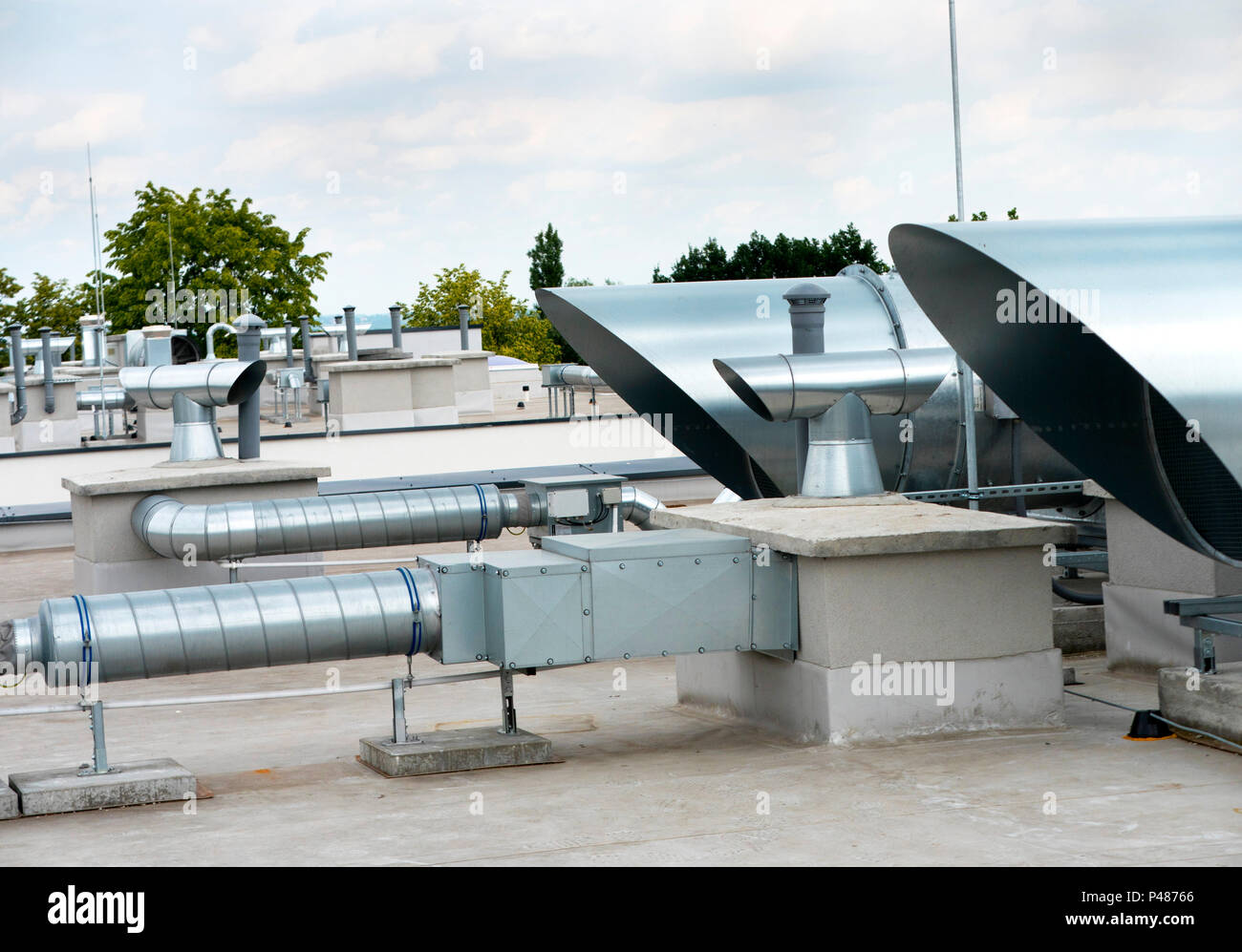 Elements of ventilation and air conditioning placed on the roof of a block of flats Stock Photo