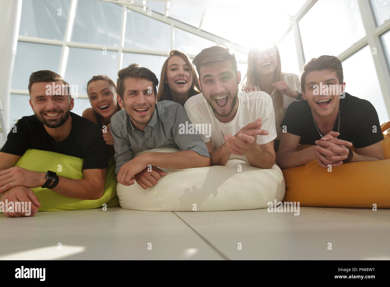 Group Of Young People Lying On The Floor And Smiling Stock Photo
