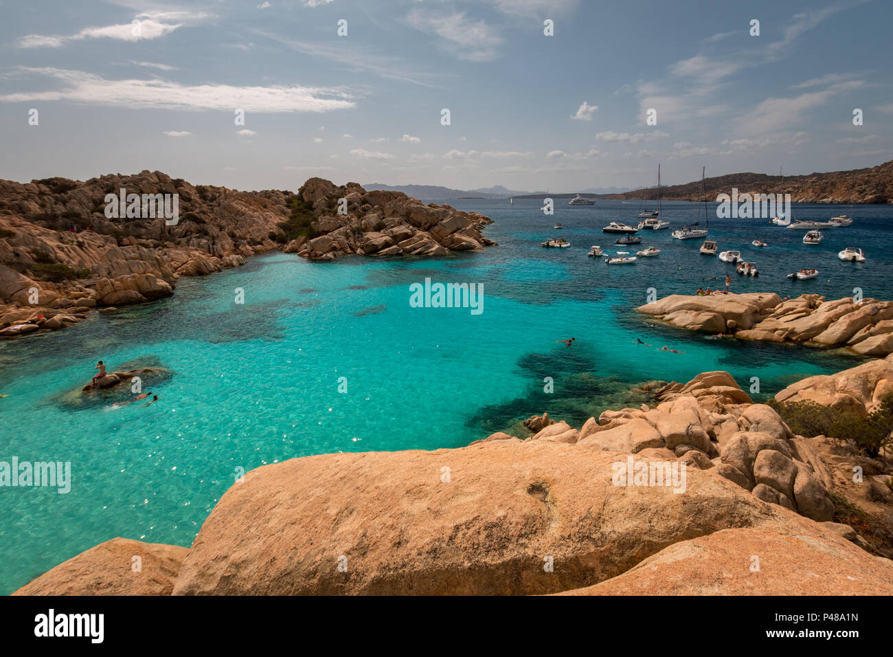 Many boats anchoring at beautiful Cala Coticcio on the Italian island