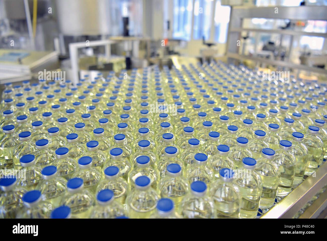 manufacture and bottling of drugs in a pharmaceutical production plant - conveyor belt with bottles Stock Photo