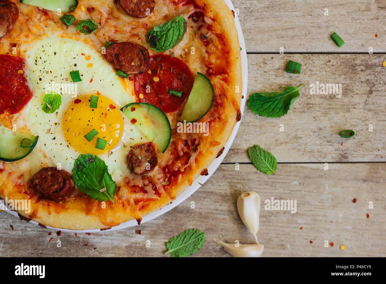 Homemade breakfast Pizza with fried egg pepperoni and veggies Stock