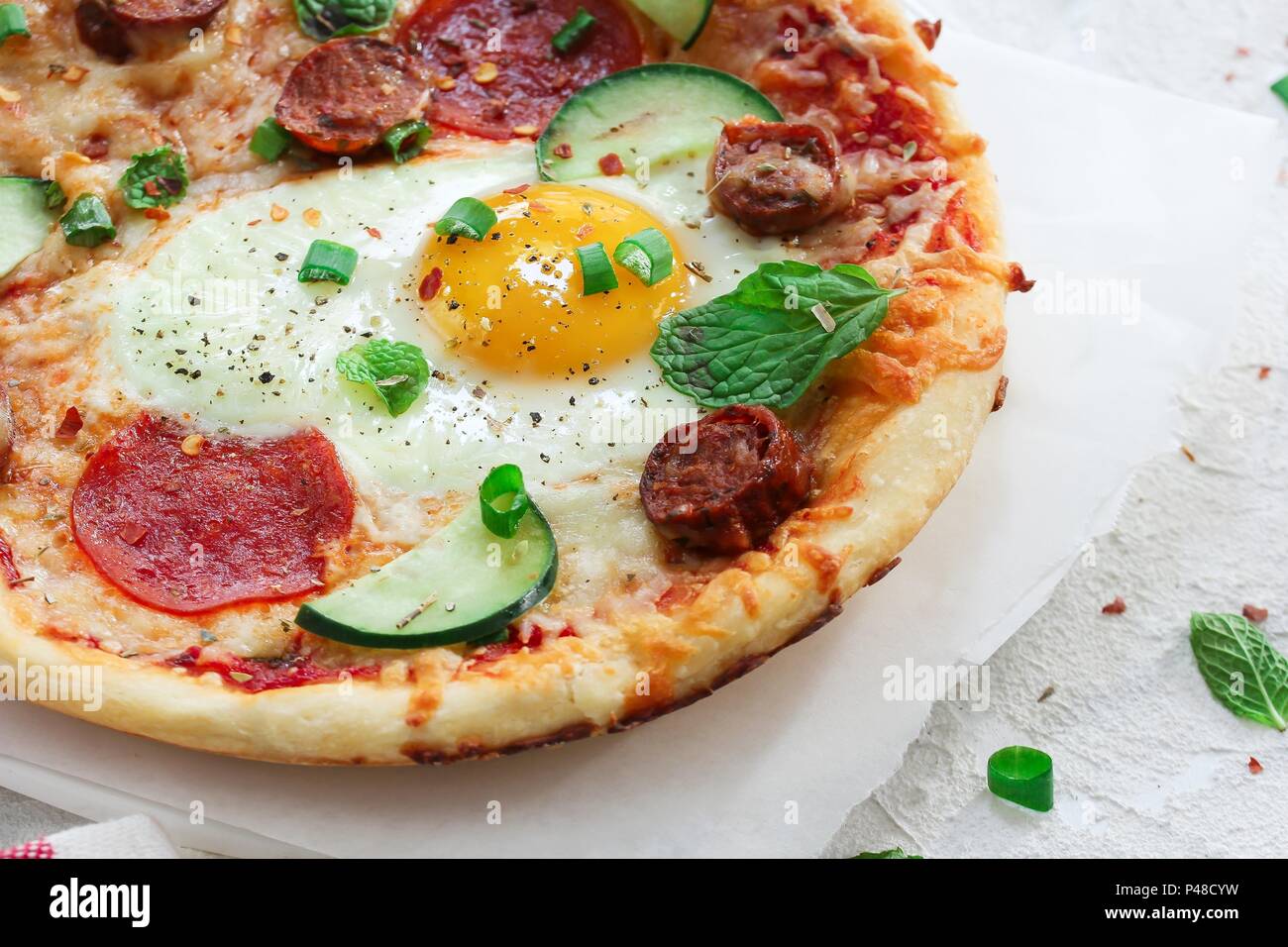 Homemade breakfast Pizza with fried egg pepperoni and veggies Stock