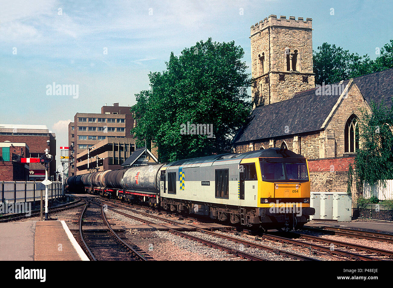 A class 60 diesel locomotive number 60054 with a train of bogie oil tanks passing the semaphores at Lincoln station on the 17th August 1993. Stock Photo