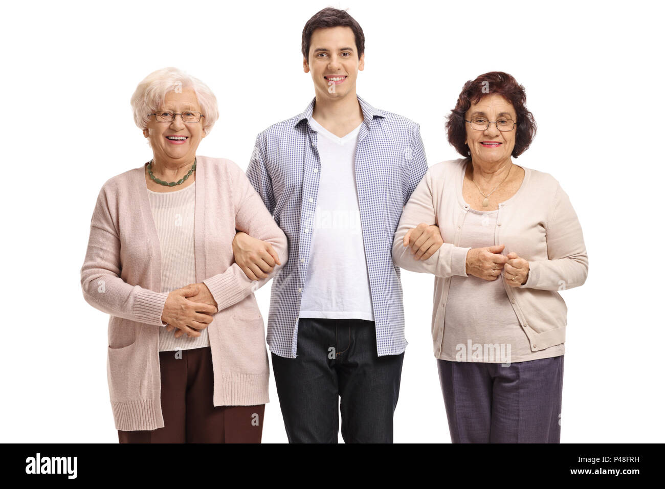 Young man with two elderly women looking at the camera and smiling isolated on white background Stock Photo
