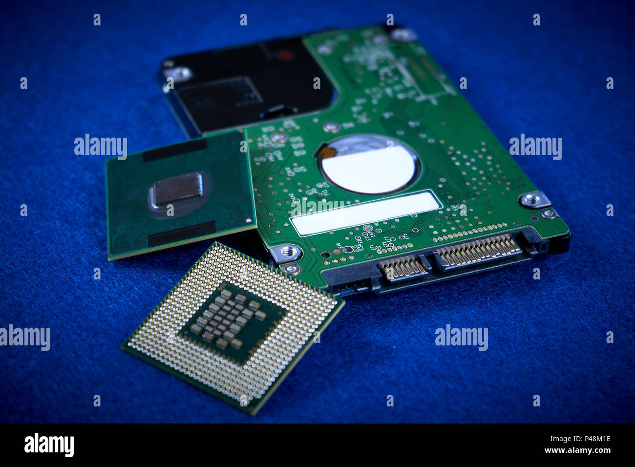 Close up of hard disk's internal mechanism hardware and two processor on blue background Stock Photo