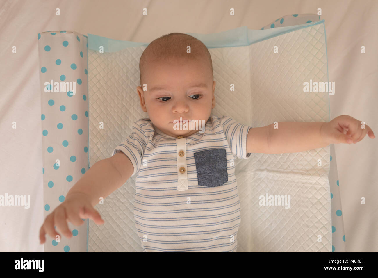 Cute little baby lying on bed Stock Photo