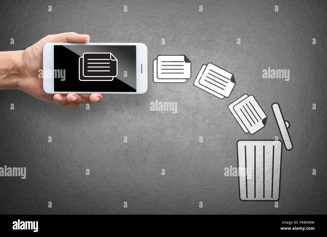business hand throw data file from mobile to trash bin Stock Photo