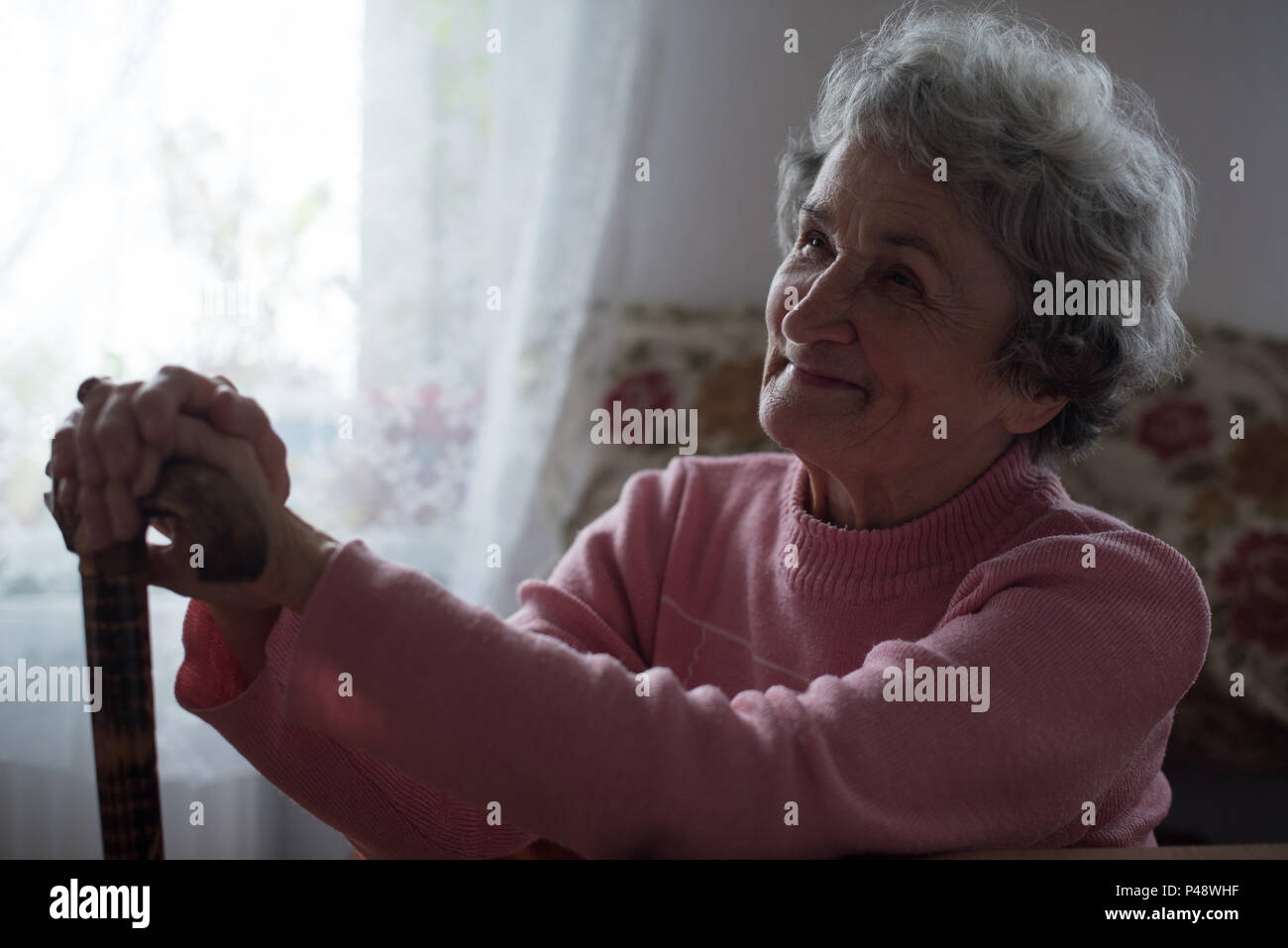 Thoughtful senior woman smiling hi-res stock photography and images - Alamy