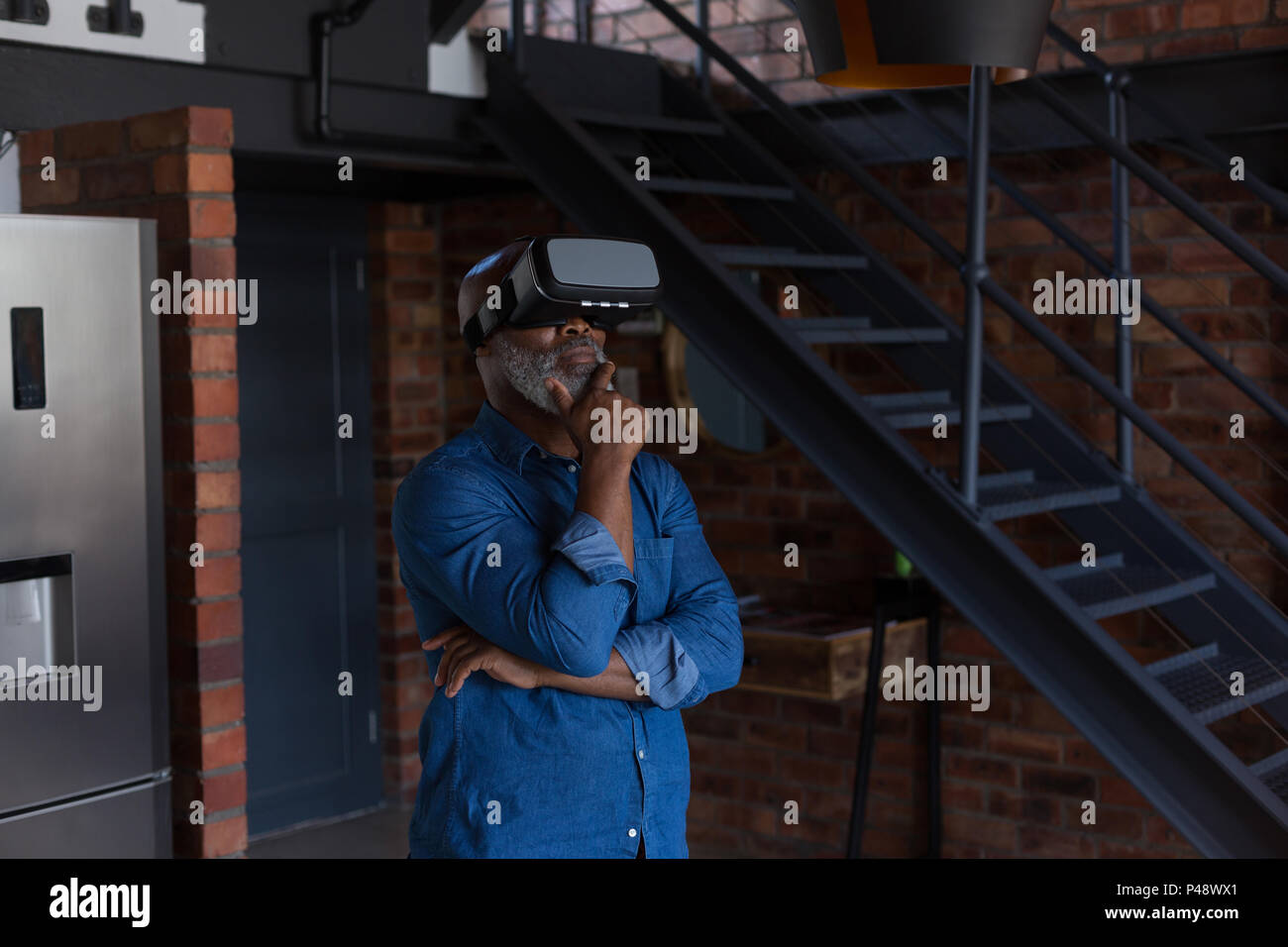 Senior man using virtual reality headset Stock Photo