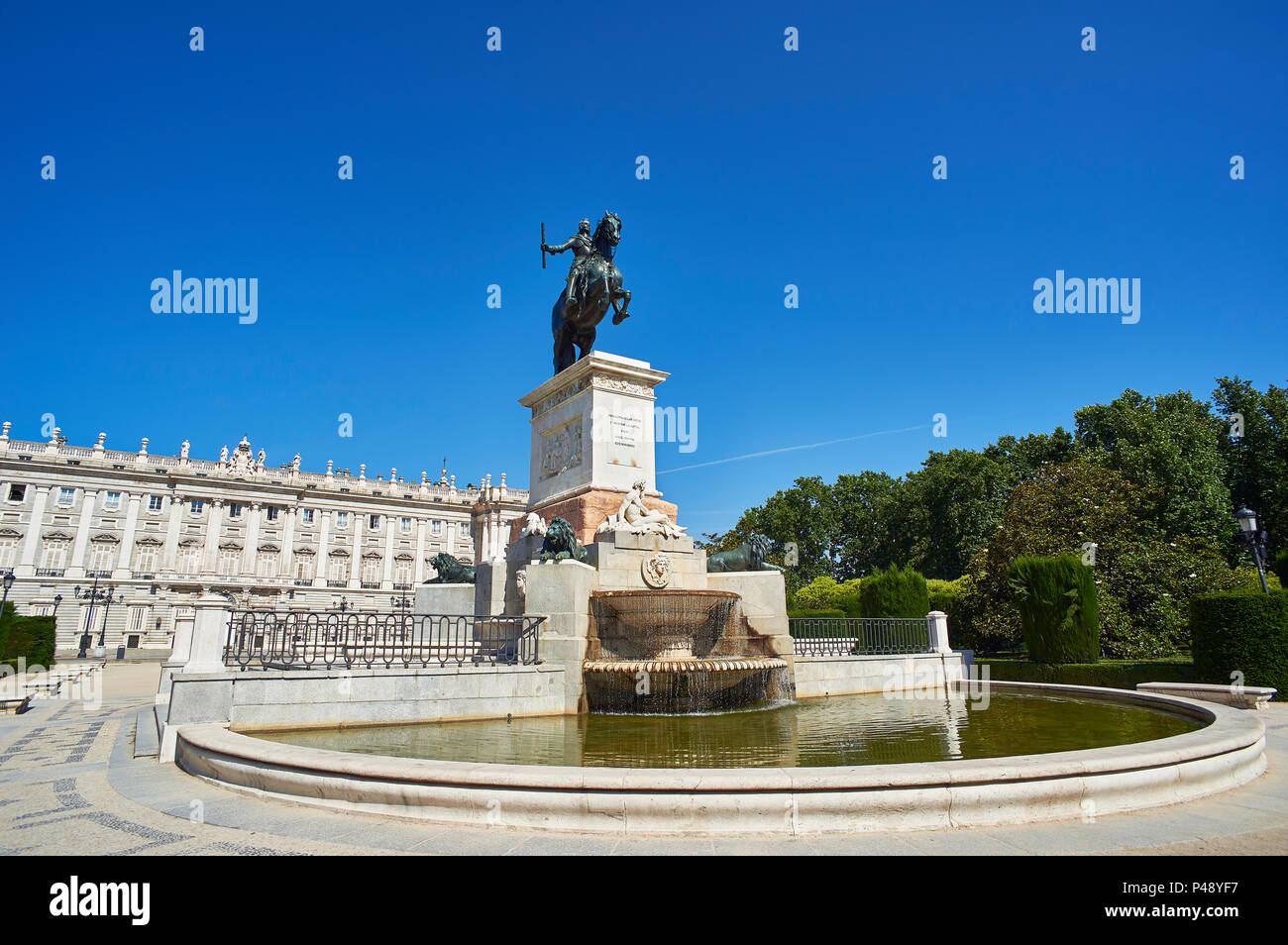 East facade of Royal Palace of Madrid (Palacio Real) with Monument to Felipe IV in foreground. Plaza de Oriente Square. Madrid, Spain. Stock Photo