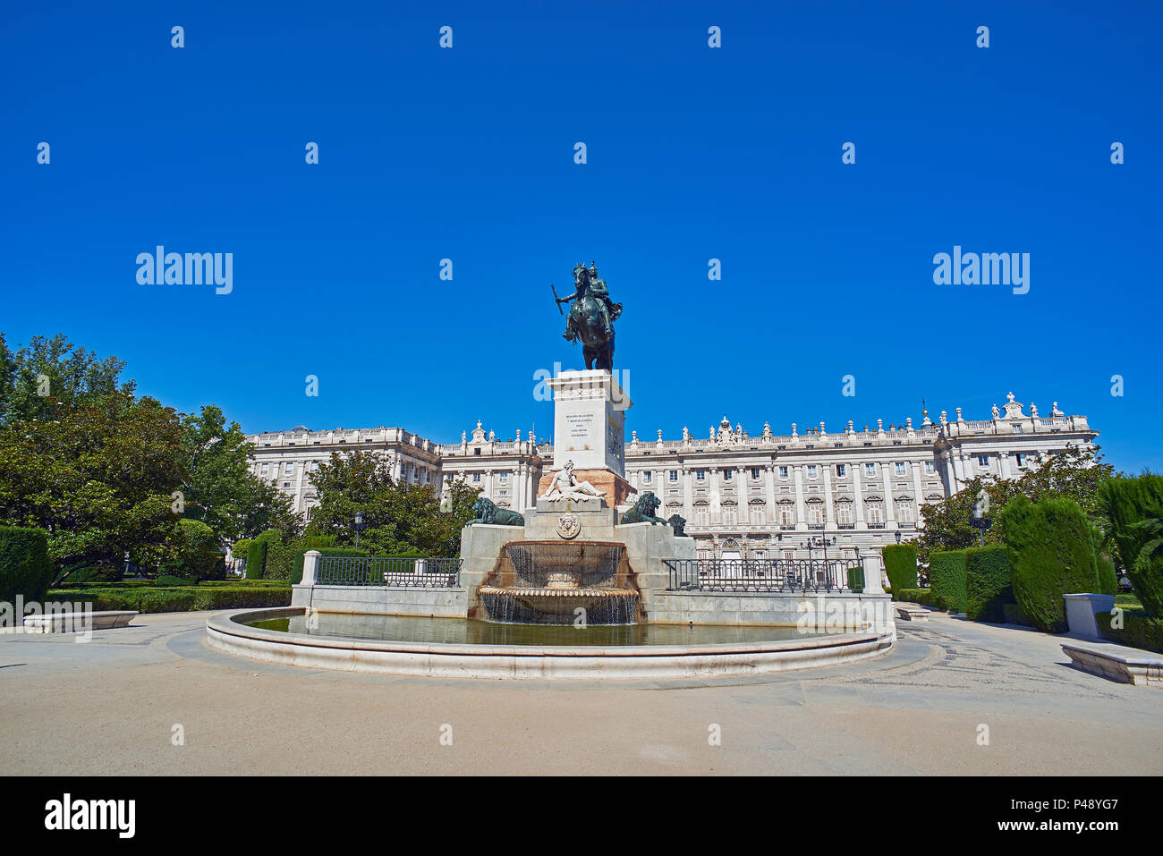 East facade of Royal Palace of Madrid (Palacio Real) with Monument to Felipe IV in foreground. Plaza de Oriente Square. Madrid, Spain. Stock Photo