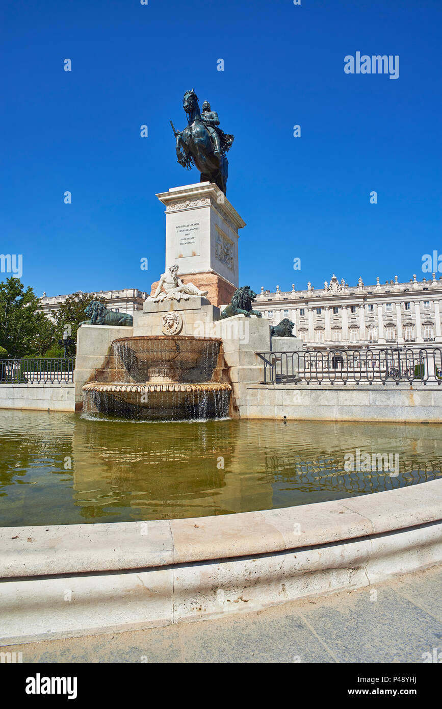 East facade of Royal Palace of Madrid (Palacio Real) with Monument to Felipe IV in foreground. Plaza de Oriente Square. Madrid, Spain. Stock Photo