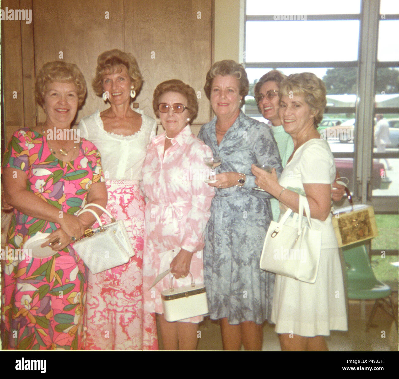 A group portrait of six women from the 1960s in floral dresses Stock Photo
