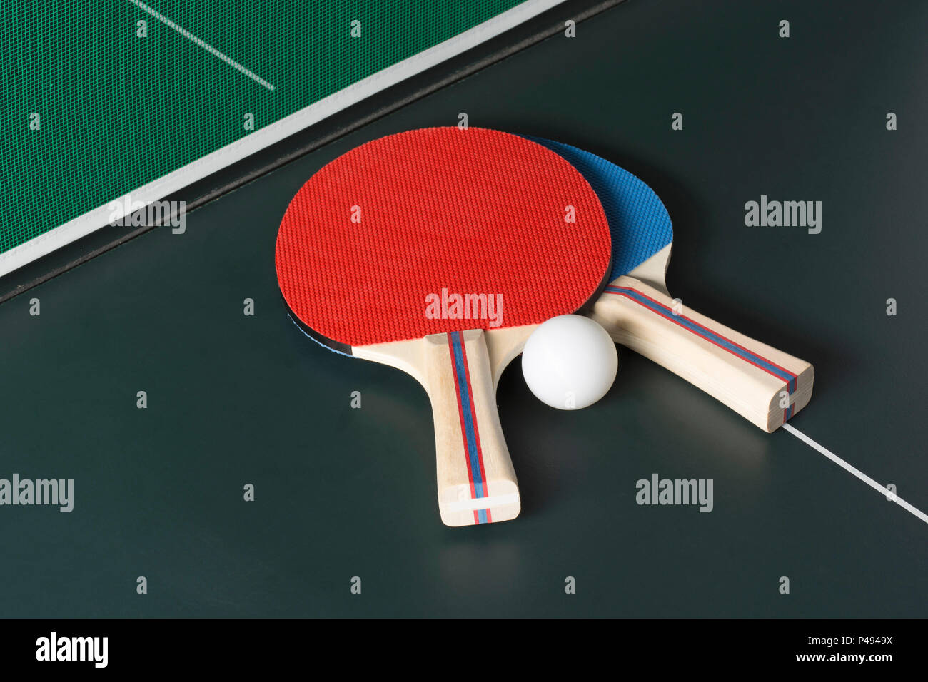 Ping Pong Paddles on a ping pong Table showing the Net, both on same