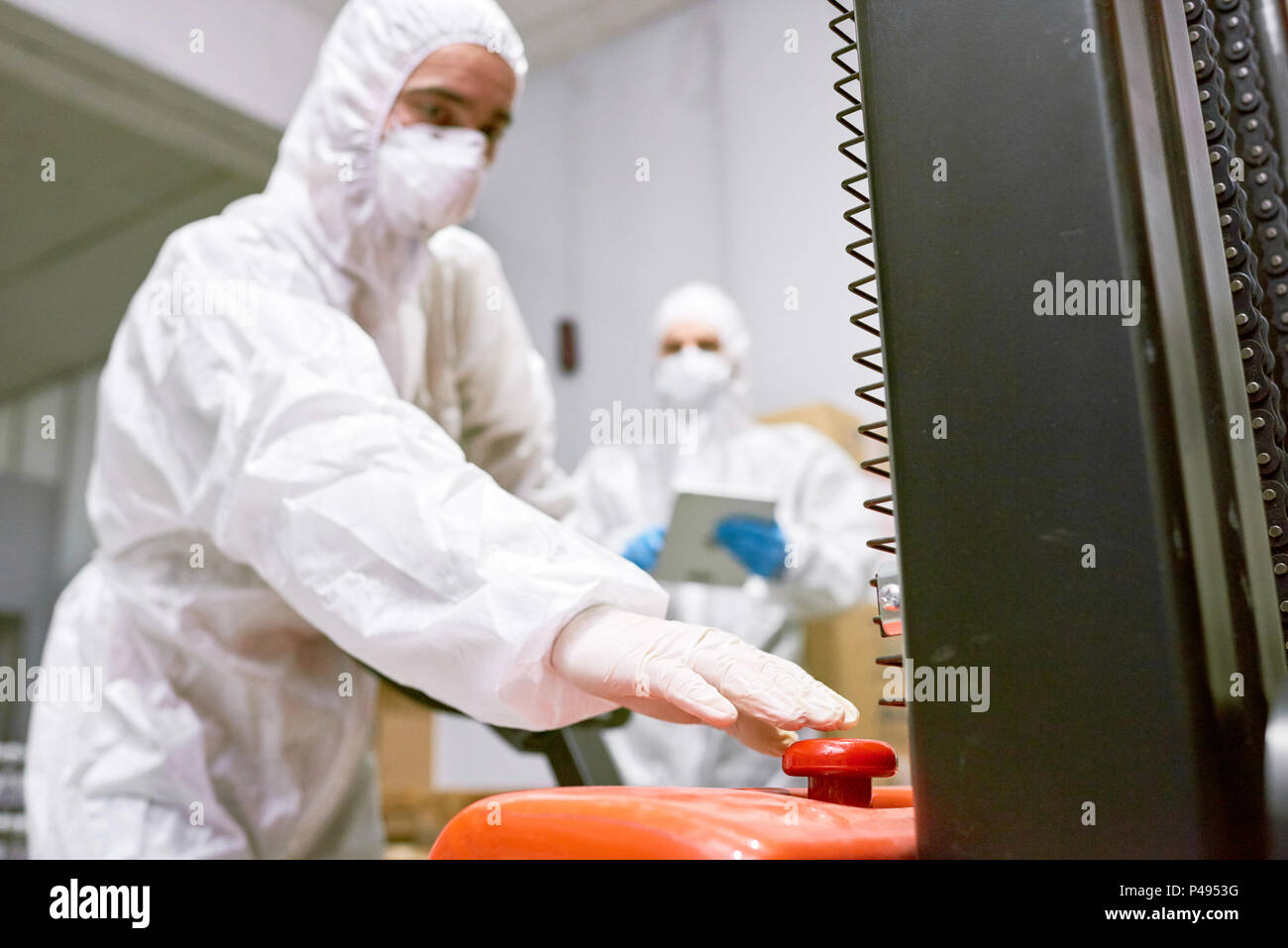 Factory worker pushing button Stock Photo