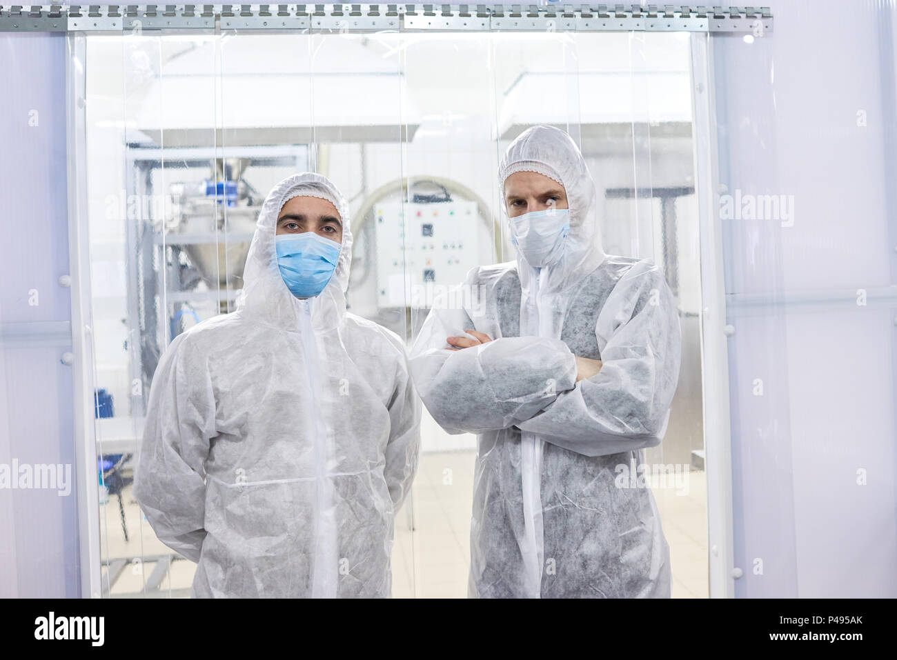 Two factory workers standing in protective clothes Stock Photo - Alamy