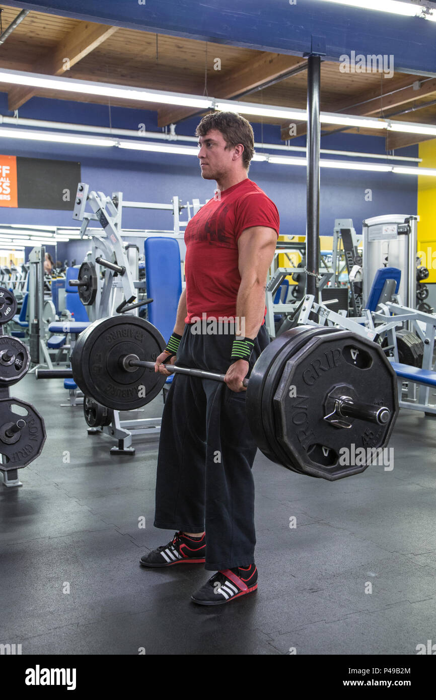 Athlete deadlifiting weights in a gym Stock Photo