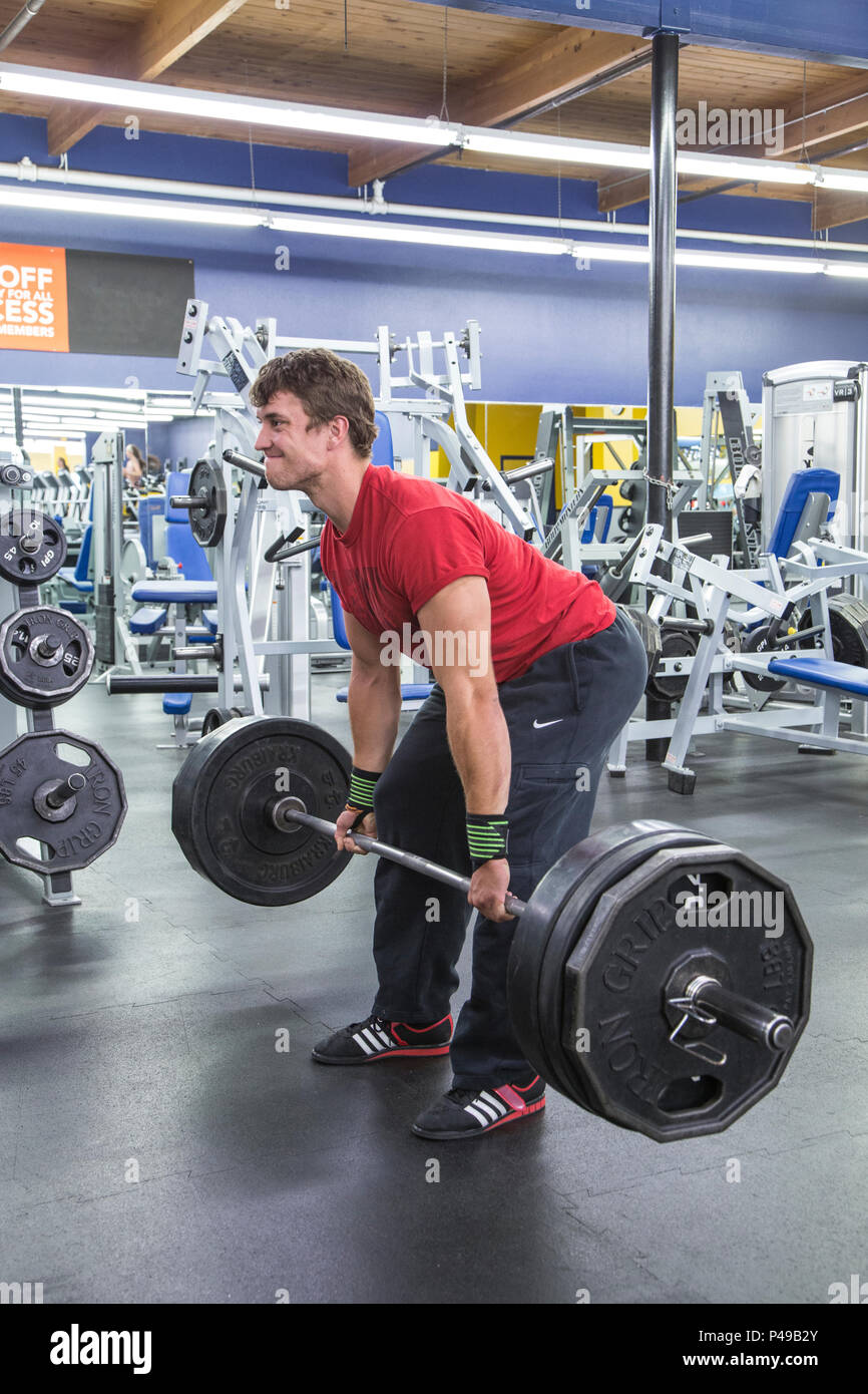 Athlete deadlifiting weights in a gym Stock Photo