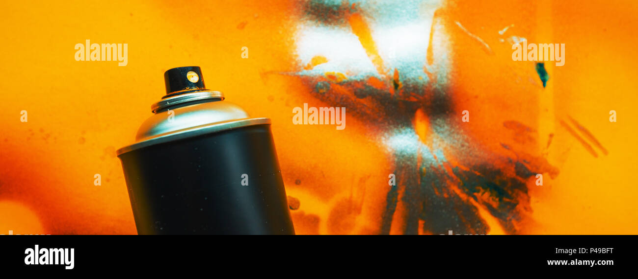 Black color spray can for graffiti artwork on grunge yellow background Stock Photo
