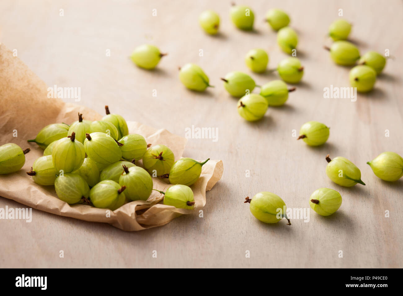 Gooseberries on white wooden background Stock Photo