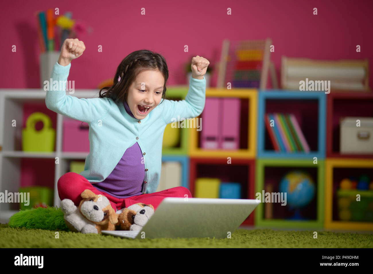 Emotional cute girl using laptop Stock Photo - Alamy