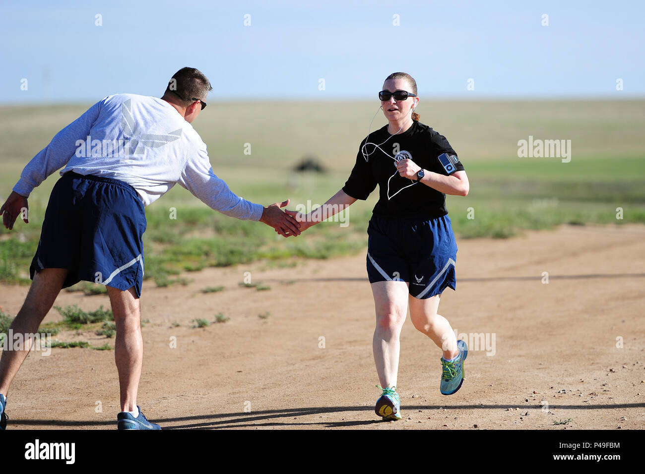 SCHRIEVER AIR FORCE BASE, Colo. -- Senior Master Sergeant Patricia Ford completes her run after participating in the 50th Space Wing's monthly Warfit Run 8 June 2016.  (U.S. Air Force Photo/Dennis Rogers) Stock Photo