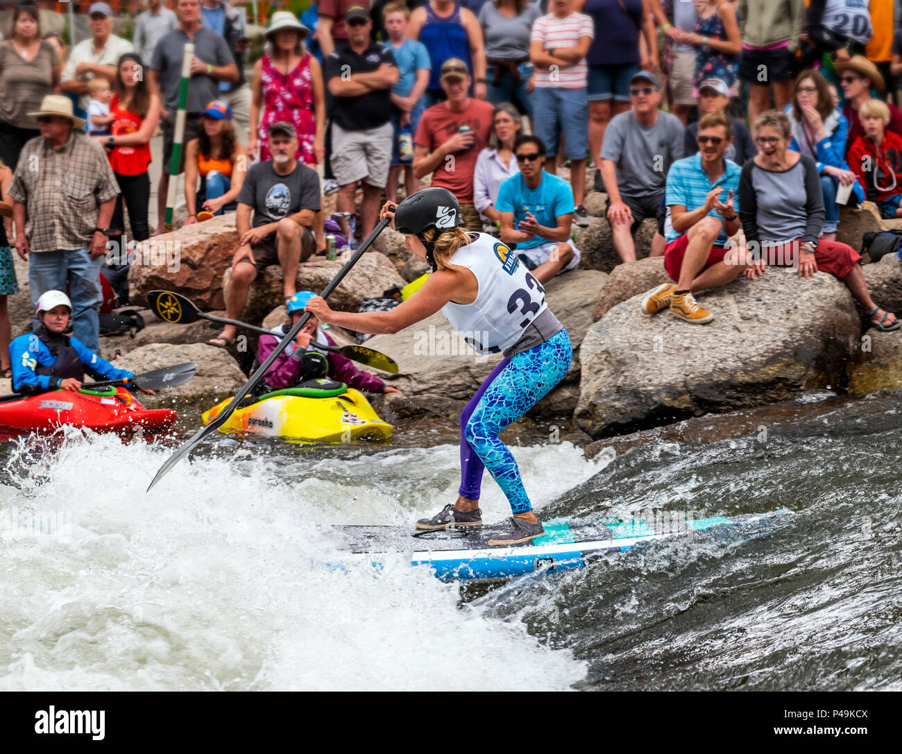 Female competitor races in standup paddleboard event; Fibark river ...