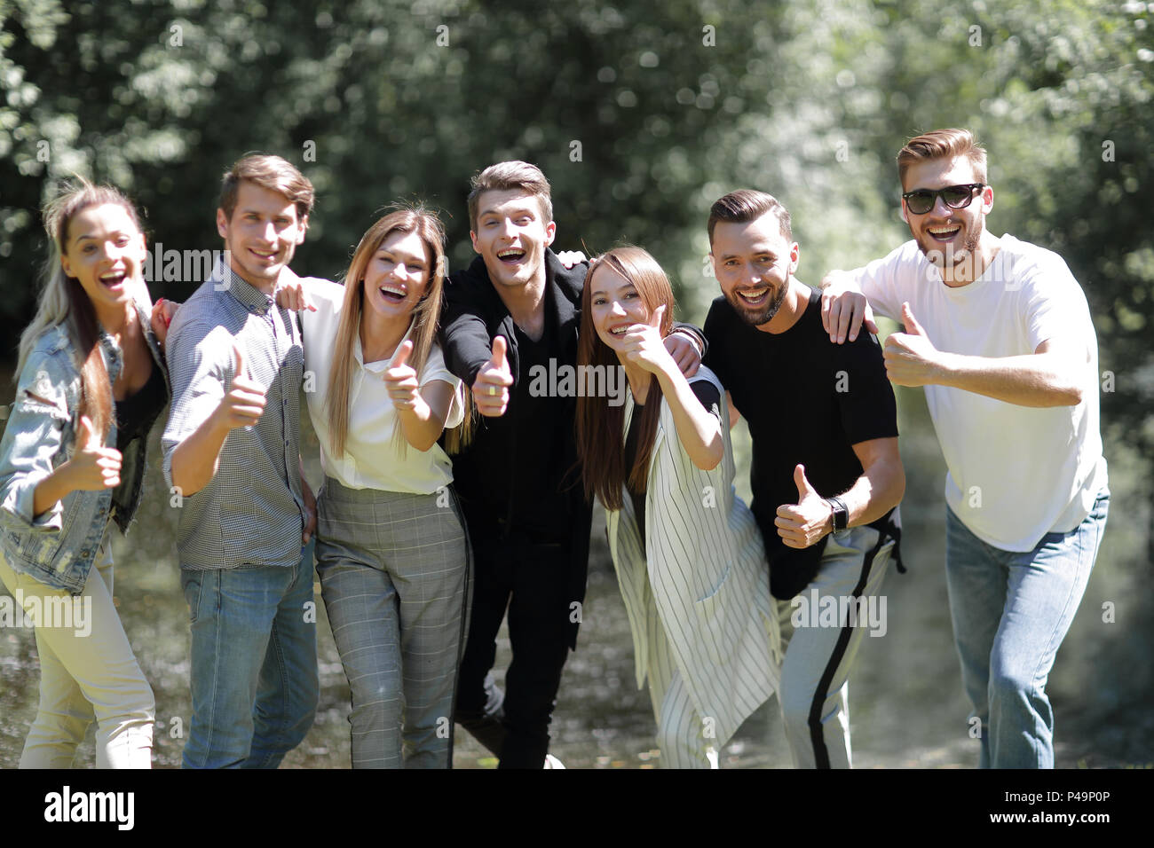 group of successful young people showing thumb up Stock Photo - Alamy