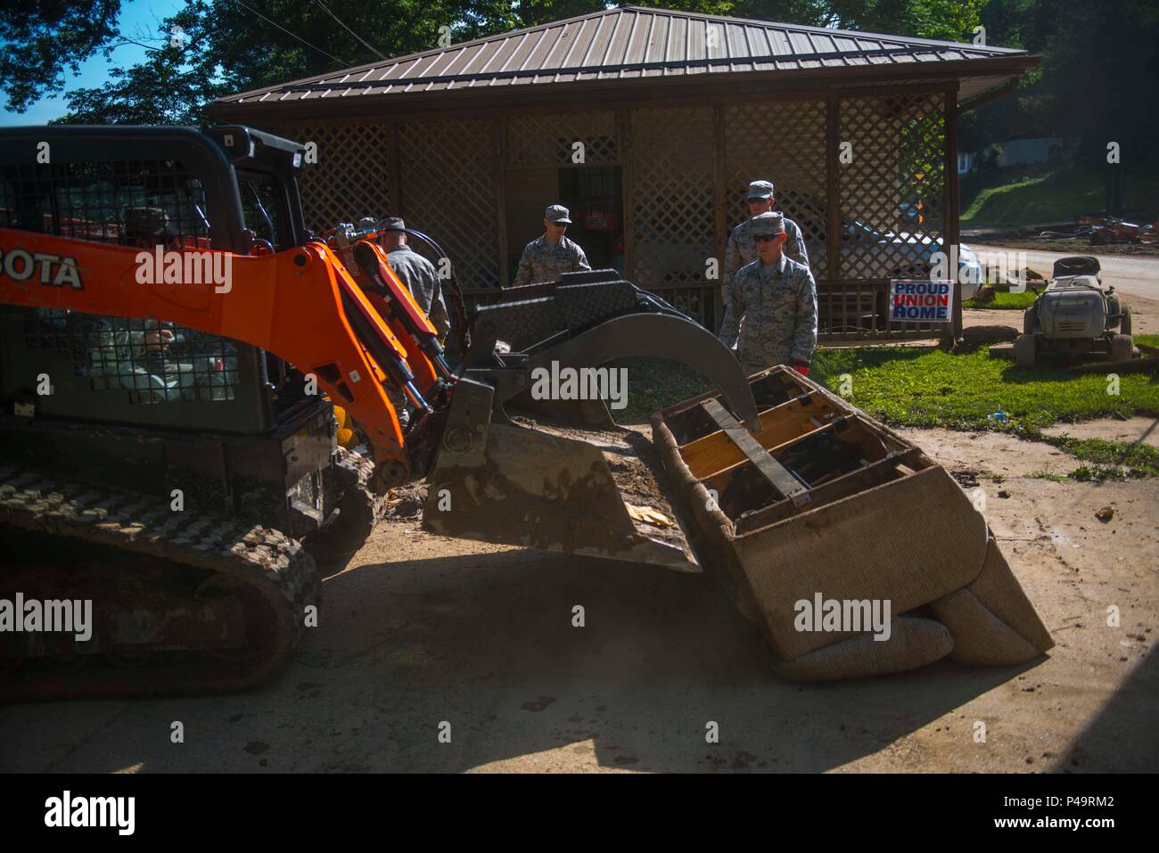 Members of the West Virginia Air National Guard clean up flood debris
