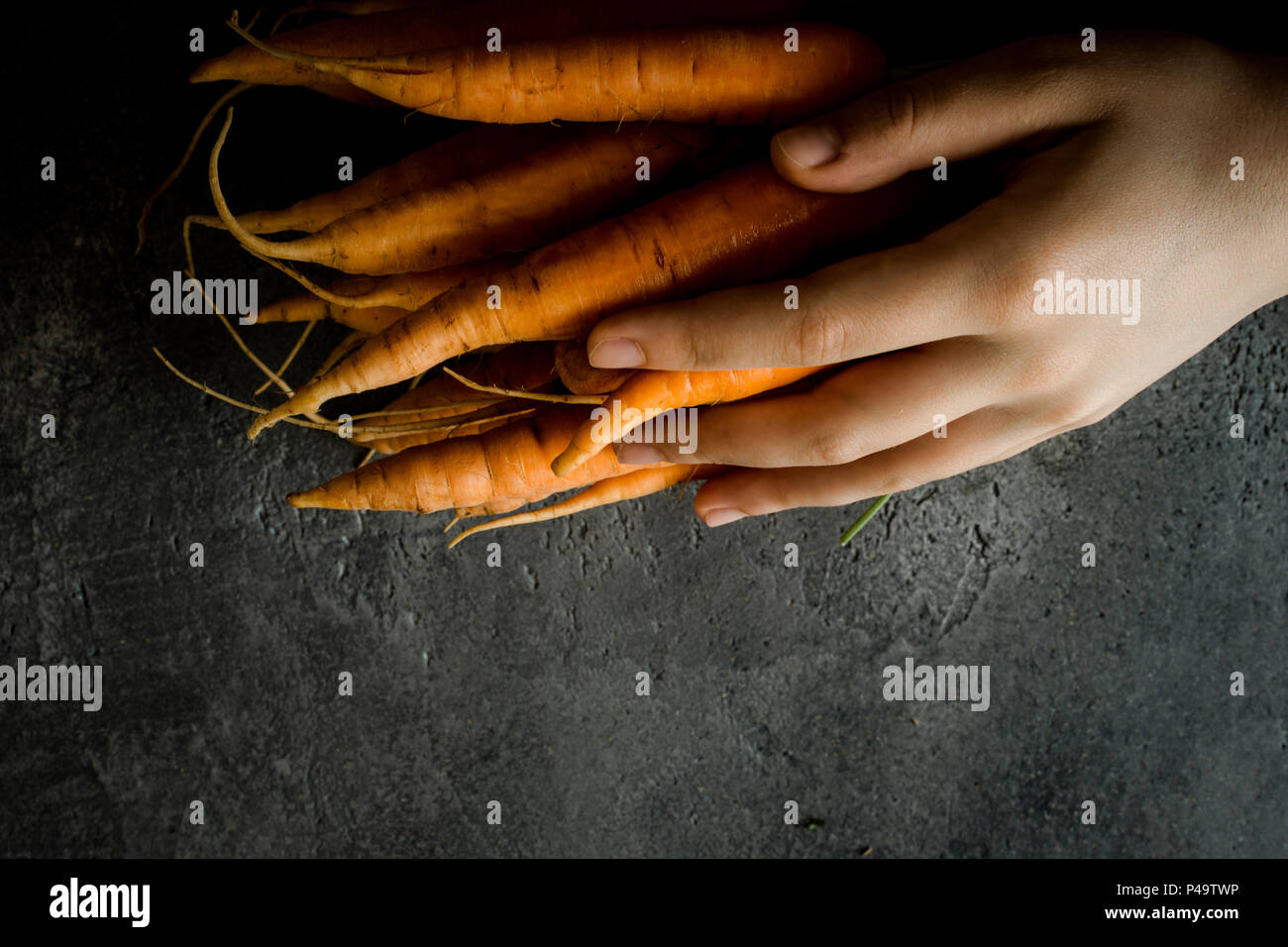 Female Hands Holding Organic Nantes Carrots. Fresh Superfood Healthy Eating Concept. Stock Photo