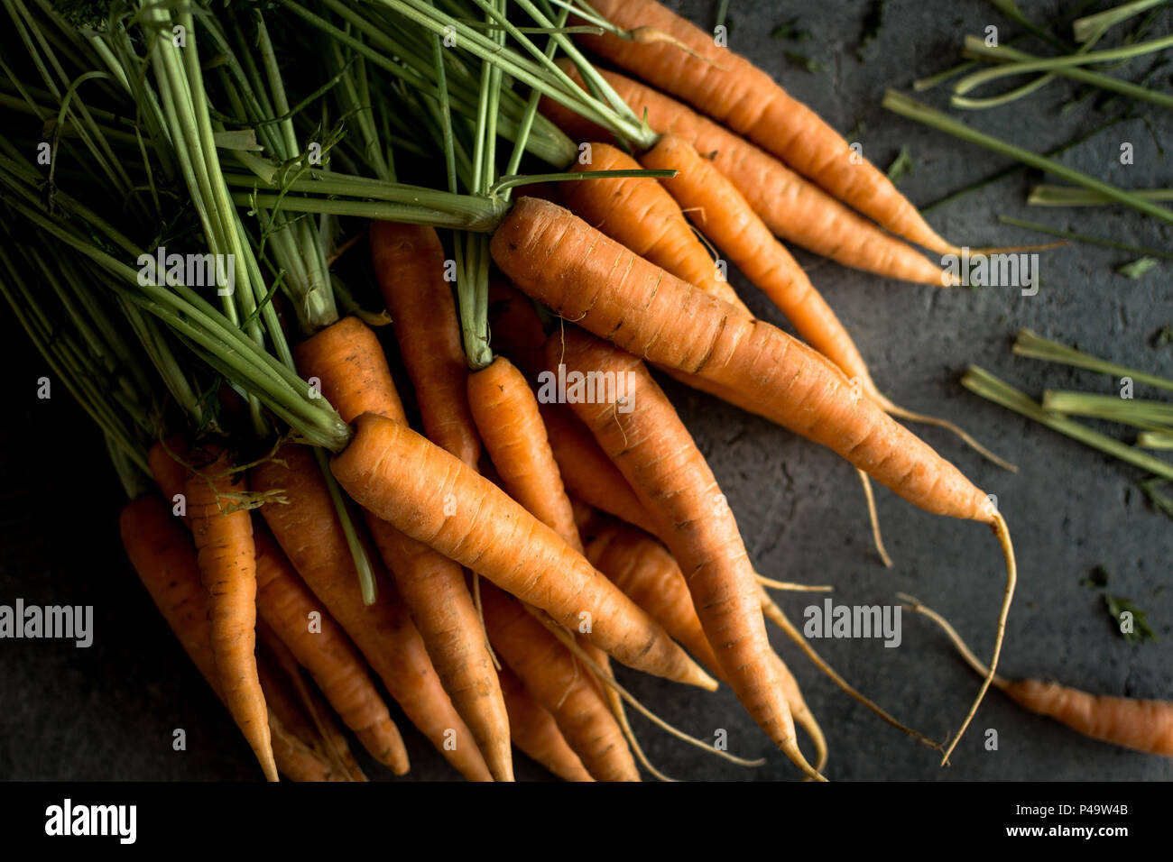 Organic Nantes Carrots on Rustic Dark Background. Fresh Superfood Healthy Eating Concept. Stock Photo