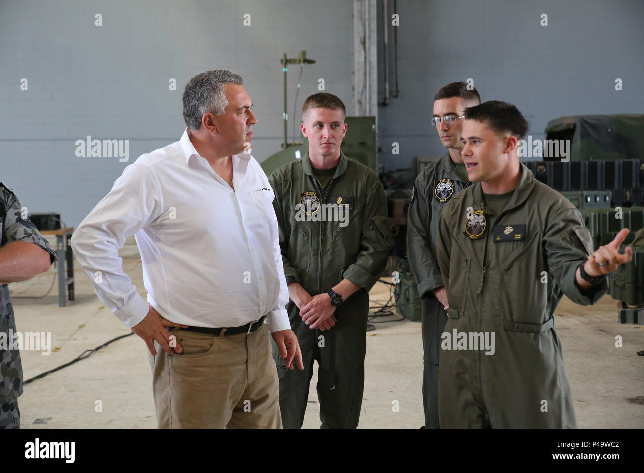 The Honorable Joe Hockey listens to Marines from Marine Aircraft Group 24 explain the different aircraft used aboard Marine Corps Air Station Kaneohe Bay, June 27, 2016.  Hockey is Australia’s ambassador to the U.S. During his visit, he discussed the importance of maintaining positive relationships between the two nations, with U.S. Marine leaders. (U.S. Marine Corps photo by Cpl. Jonathan E. LopezCruet) Stock Photo