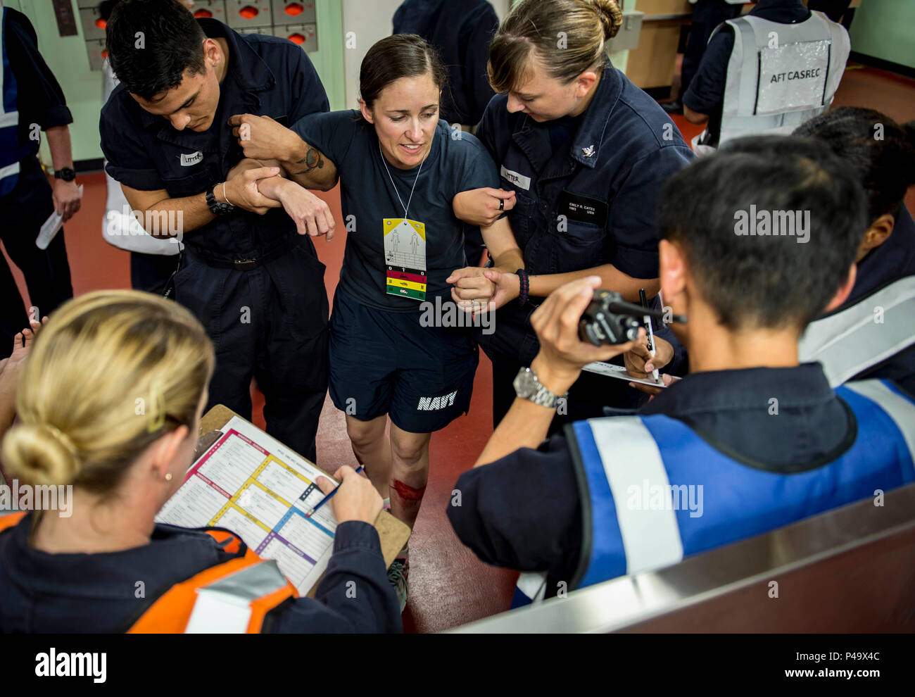 160624-N-QW941-128 PHILIPPINES SEA (June 24, 2016) Lt. Jennifer Knapp (center), a native of Agua Dulce, California, simulates being injured during a mass casualty drill aboard hospital ship USNS Mercy (T-AH 19). Deployed in support of Pacific Partnership 2016, medical, engineering and various other personnel embarked aboard Mercy are working side-by-side with partner nation counterparts, exchanging ideas, building best practices and relationships to ensure preparedness should disaster strike. (U.S. Navy photo by Mass Communication Specialist 3rd Class Trevor Kohlrus/Released) Stock Photo