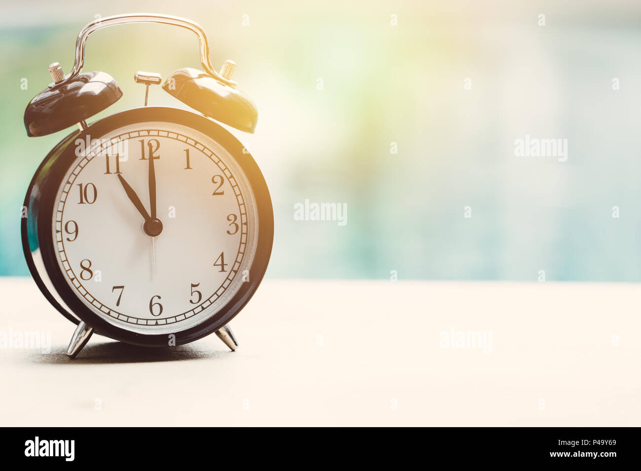 11 o'clock retro clock at the swimming pool outdoor relax time holiday time concept. Stock Photo