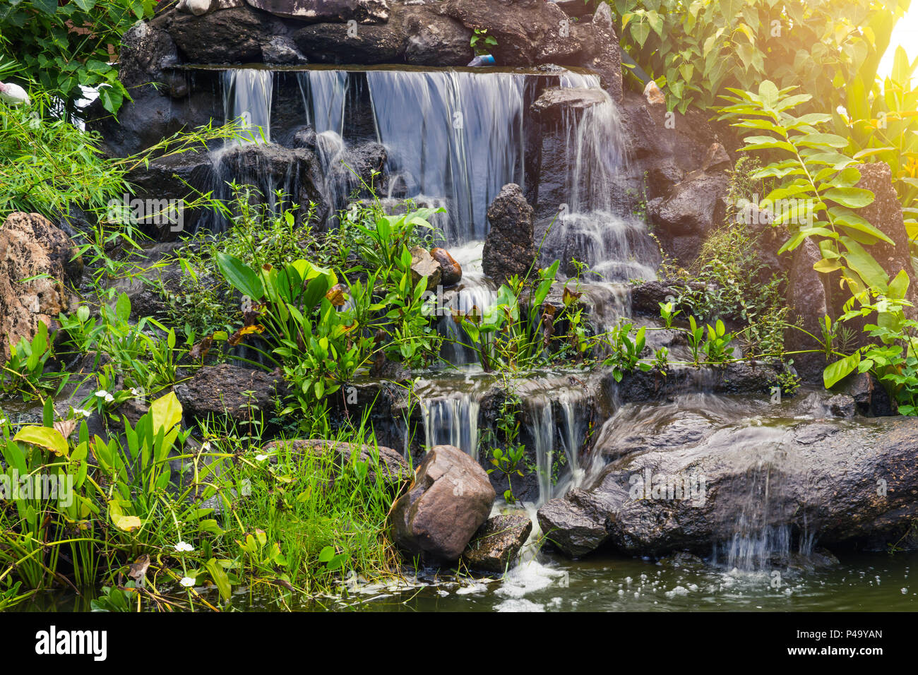 Artificial small Water fall in the park garden home green space decoration Photo Alamy
