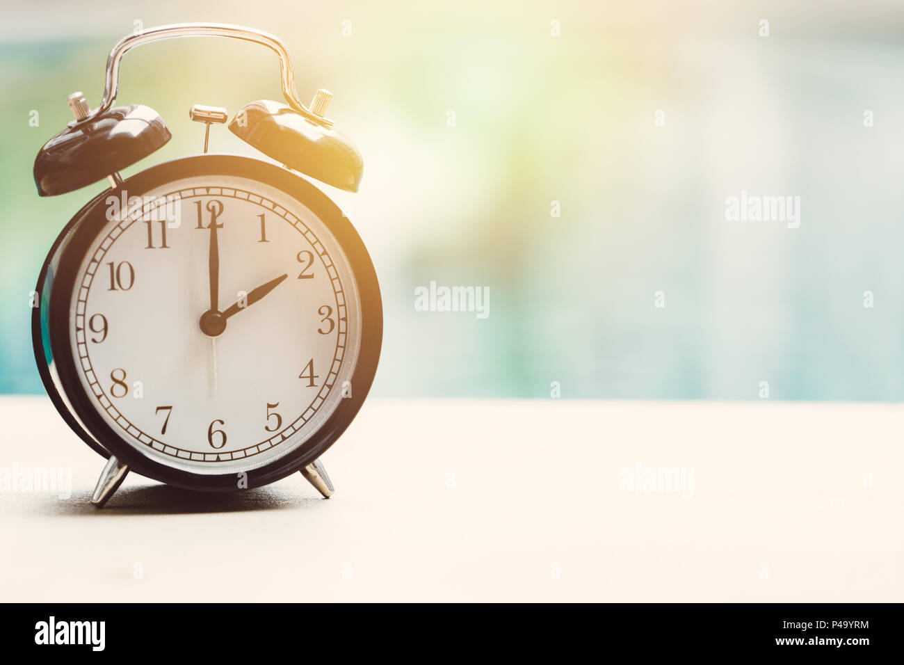 2 o'clock retro clock at the swimming pool outdoor relax time holiday time concept. Stock Photo