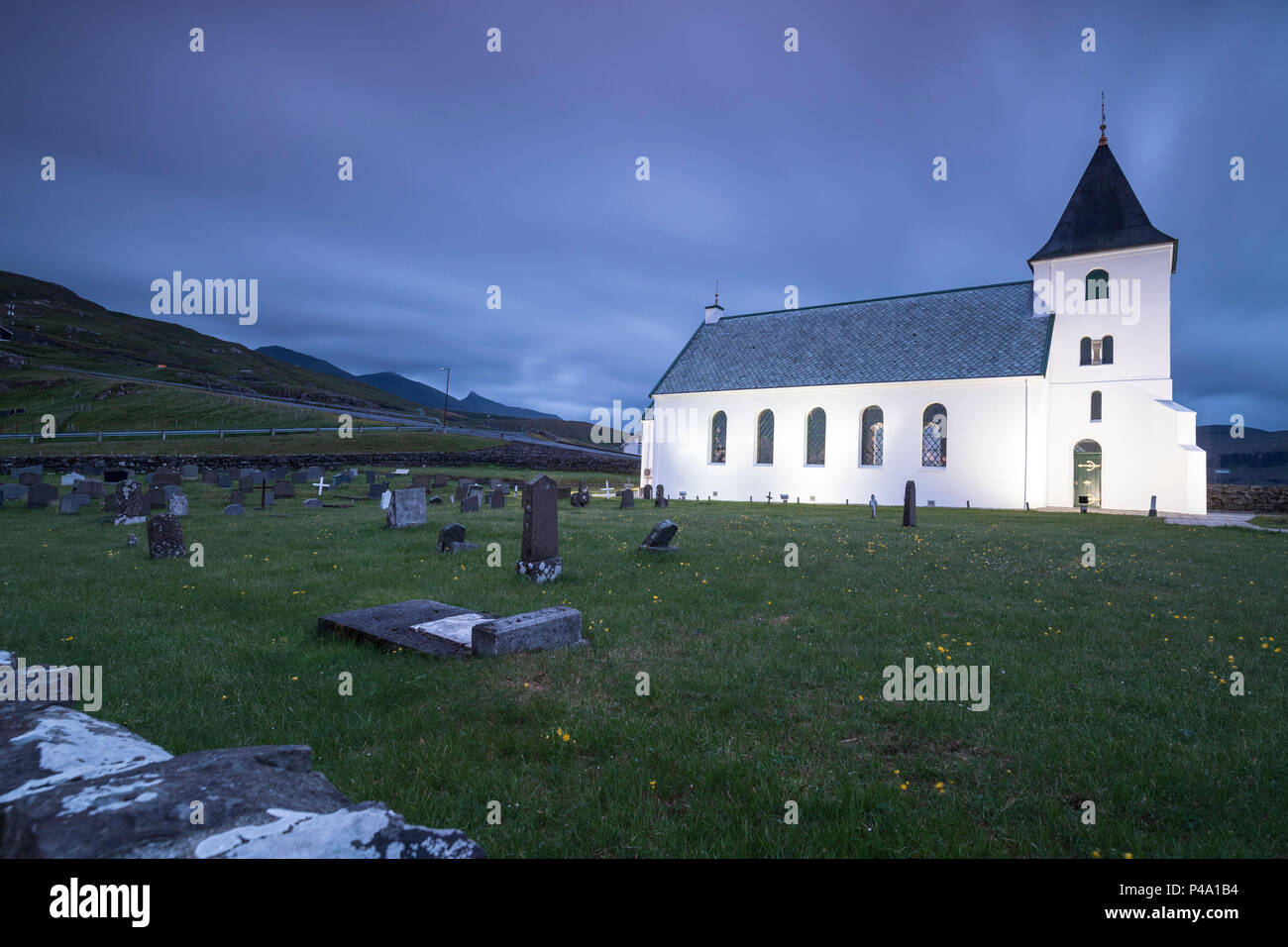 Church of Eidi and cemetery at dusk, Eysturoy Island, Faroe Islands Stock Photo