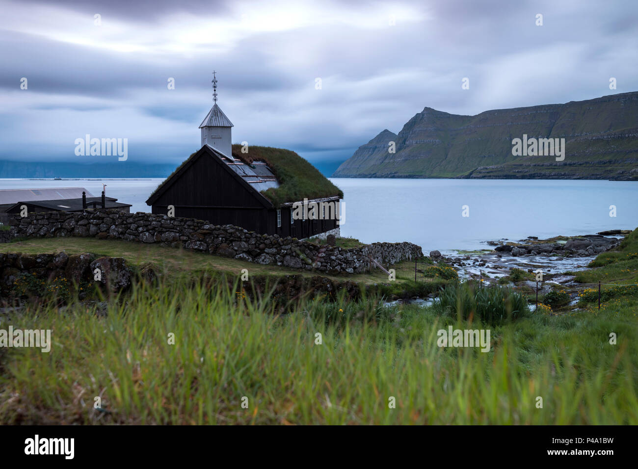 Cloudy sky on the historic church in Funningur, Eysturoy Island, Faroe islands Stock Photo
