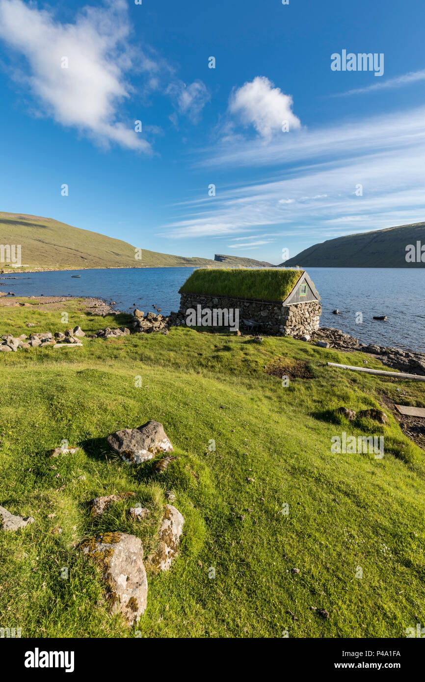 Isolated house on the shore of lake Sorvagsvatn, Vagar Island, Faroe Islands Stock Photo