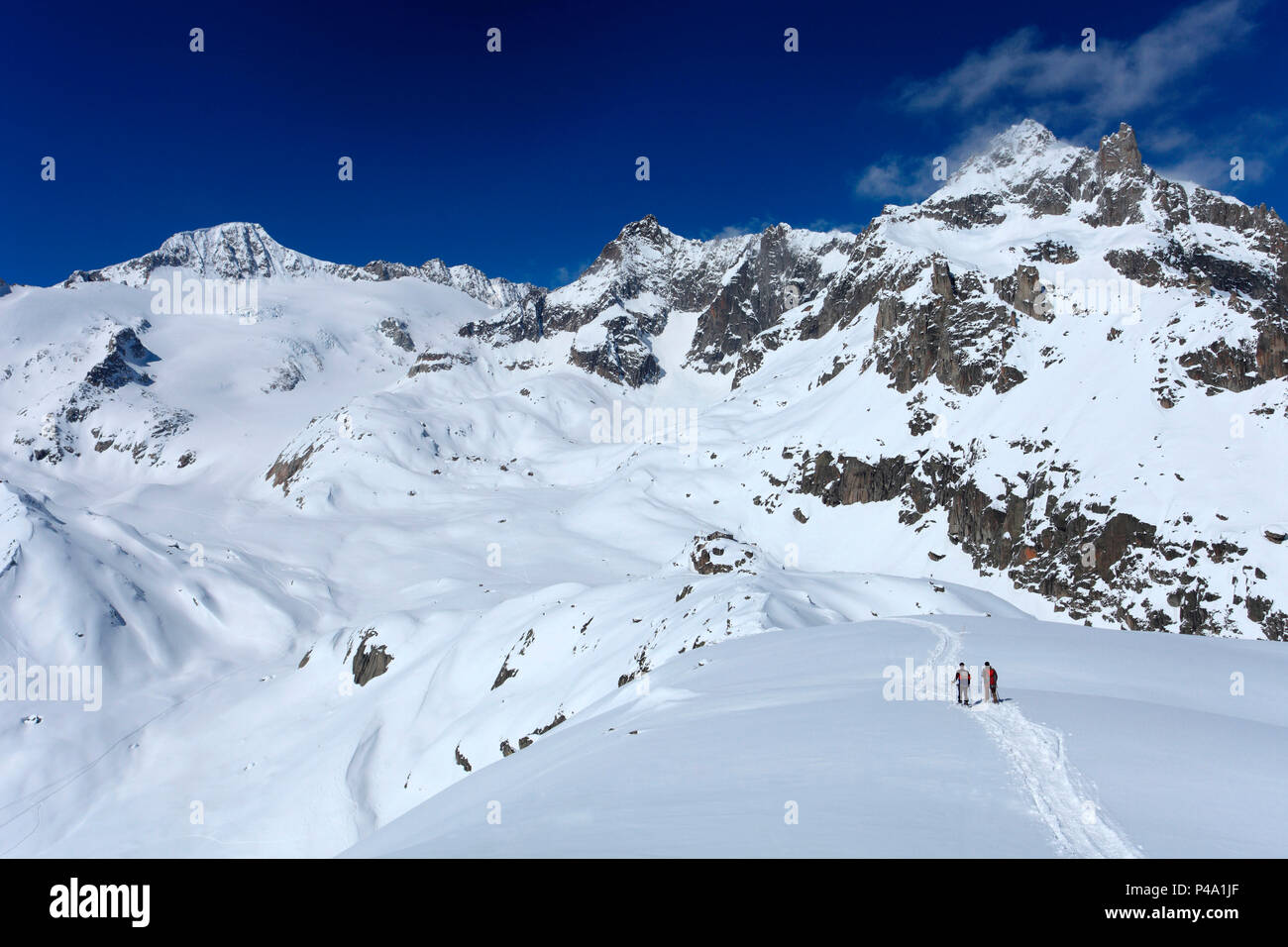 Hikers towards Albert Heim Hütte, with Galenstock summit in the background, Realp, Uri, Switzerland Stock Photo