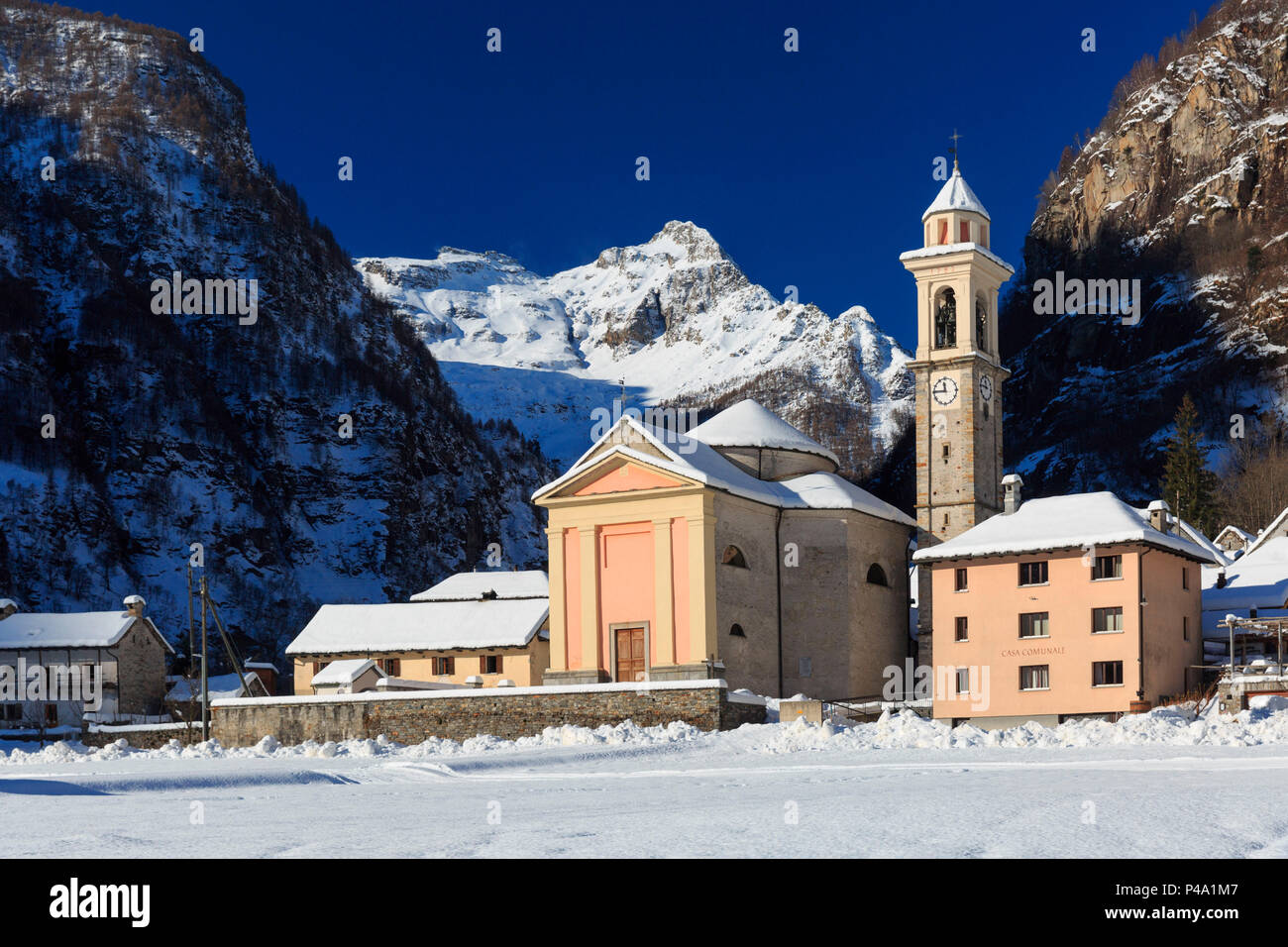 The church of the village Sonogno in winter with Mount Zucchero in the background, Sonogno, Val Verzasca, Canton Ticino, Switzerland, Europe Stock Photo