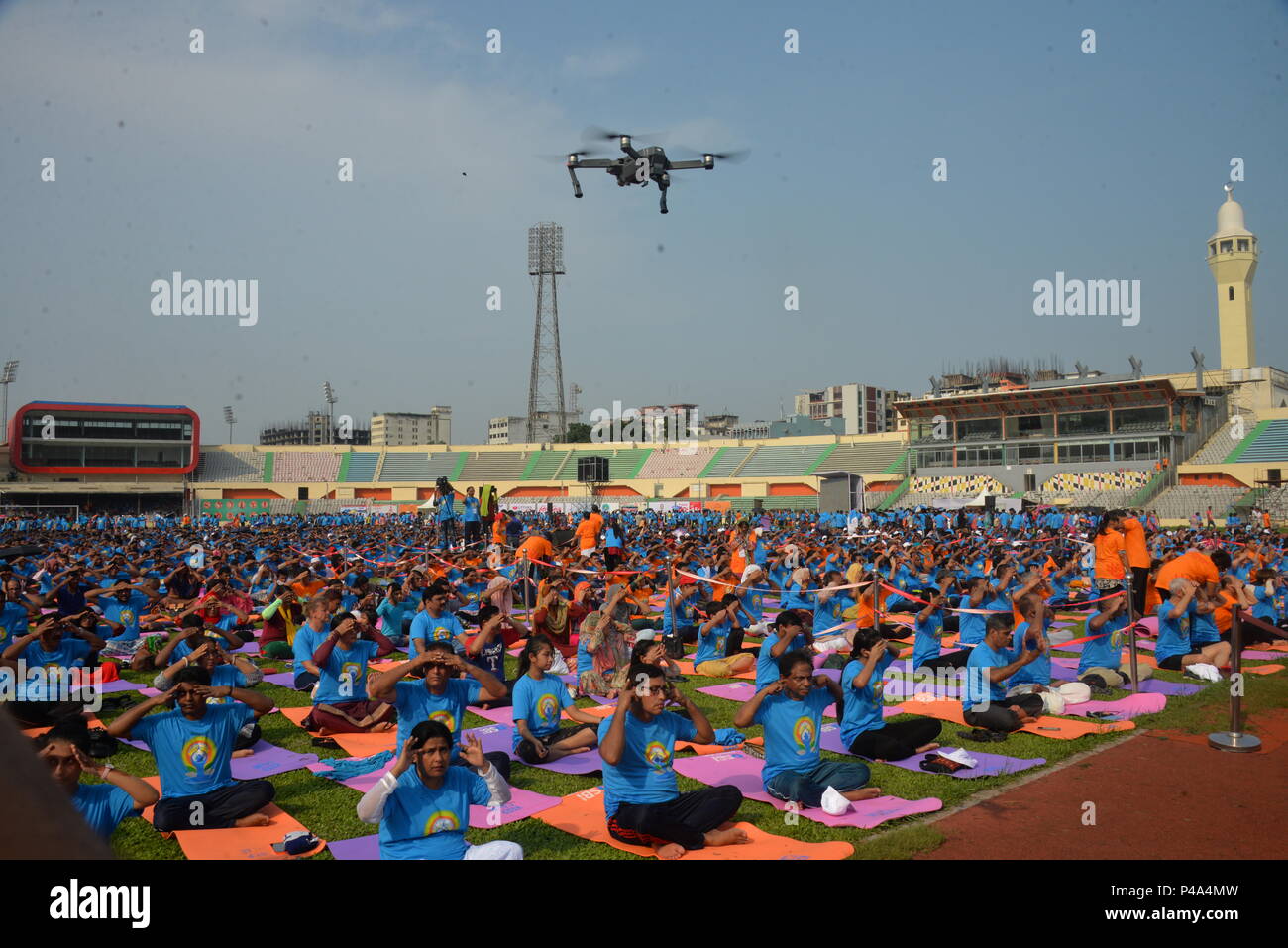 Dhaka. 21st June, 2018. People practice yoga during a gathering event marking the International Yoga Day at Bangabandhu National Stadium in Dhaka, Bangladesh on June 21, 2018. The United Nations has declared June 21 as the International Yoga Day. Credit: Xinhua/Alamy Live News Stock Photo