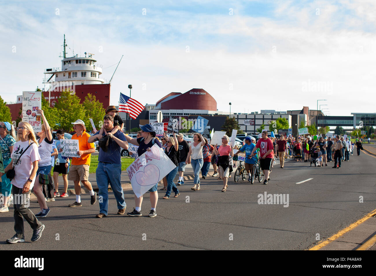 DULUTH, MINNESOTA, USA - June 20, 2018: A large crowd of protesters march in front of Amsoil arena while President Donald Trump speaks at a rally Wednesday night. Credit: Theresa Scarbrough/Alamy Live News Stock Photo