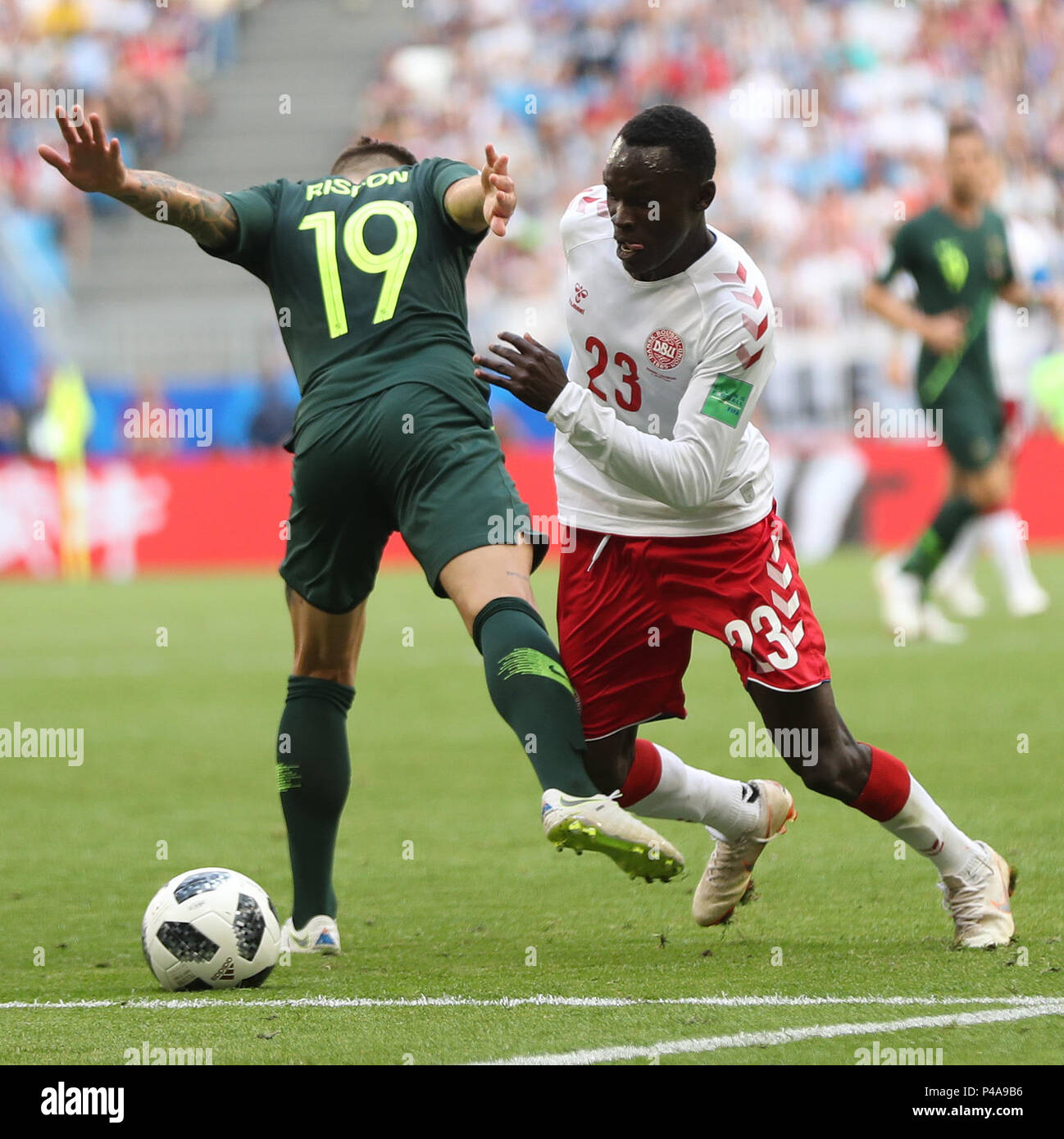 Samara, Russia. 21st June, 2018. Pione Sisto (R) of Denmark vies with Joshua Risdon of Australia during the 2018 FIFA World Cup Group C match between Denmark and Australia in Samara, Russia, June 21, 2018. The match ended in a 1-1 draw. Credit: Fei Maohua/Xinhua/Alamy Live News Stock Photo