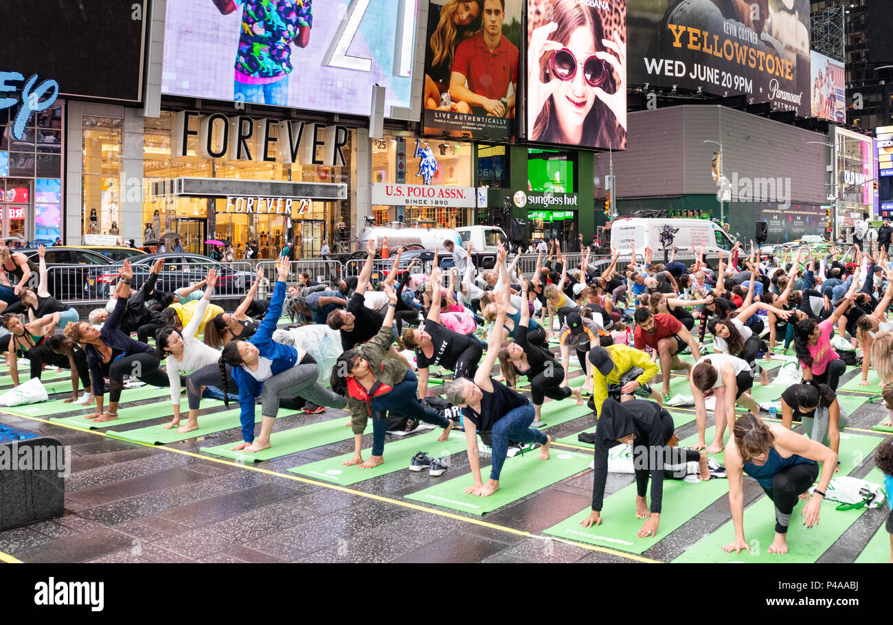 General view of people performing Yoga. Large yoga session in Times