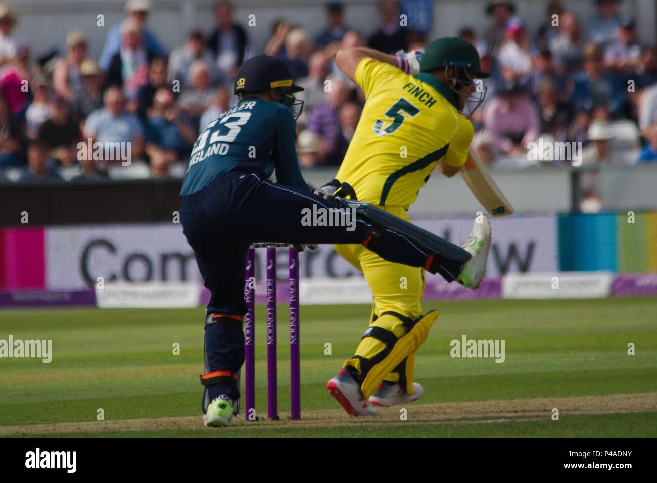 Chester-le-Street, England 21 June 2018. Jos Buttler, keeping wicket for England raises a leg as Aaron Finch bats for Australia in the fourth ODI at Emirates Riverside.  Credit: Colin Edwards/Alamy Live News. Stock Photo